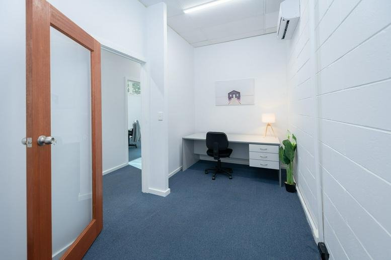 Internal office suite at 119 Murray street, Gawler, Adelaide, South Australia with a desk and blue carpeting.