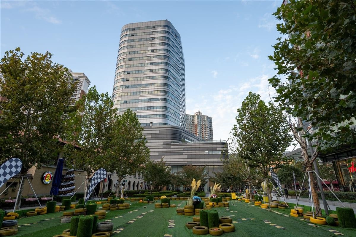Exterior view of the curved glass-facade tower at 1193, Changning Road, Changning District.