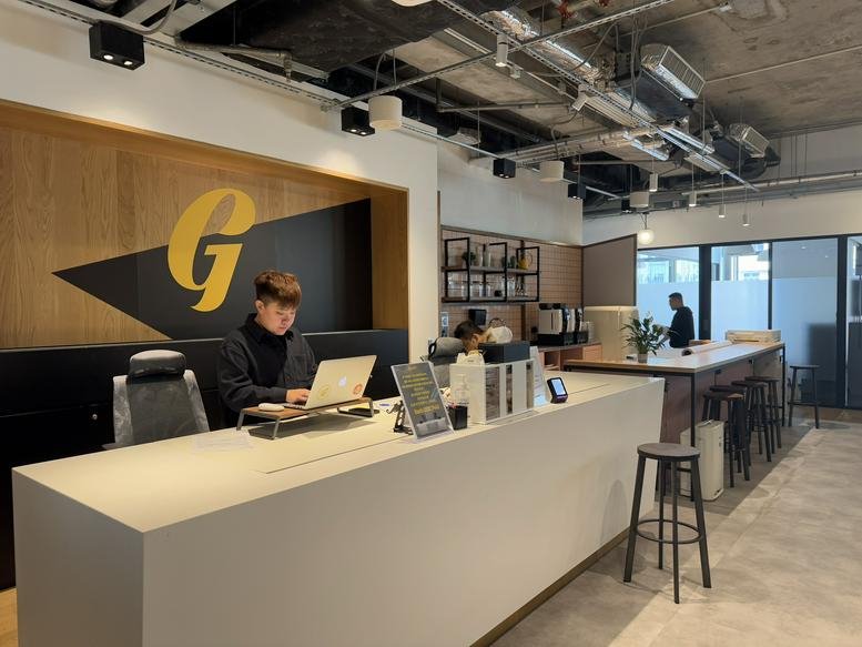 Reception at 11f, 535, Jaffe Road with a large golden G logo and a white front desk.