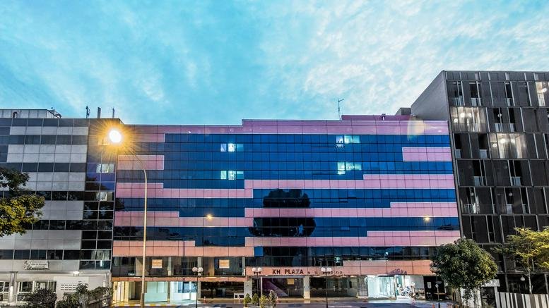 Exterior view of the glass-facade and geometric patterned KH Plaza building.