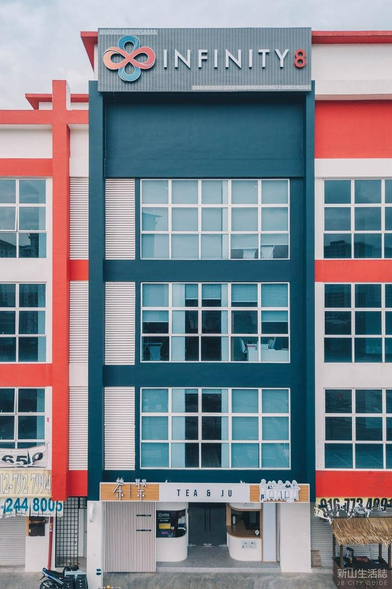 Exterior view of the colorful red and blue building facade at 121 Jalan Mutiara Emas 2A.