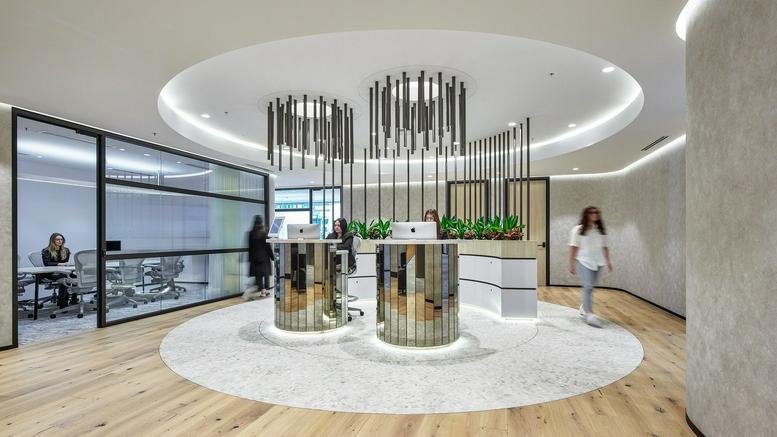Circular lobby at 123 Pitt Street, Angel Place with gold reception desks and unique hanging metal light fixture.