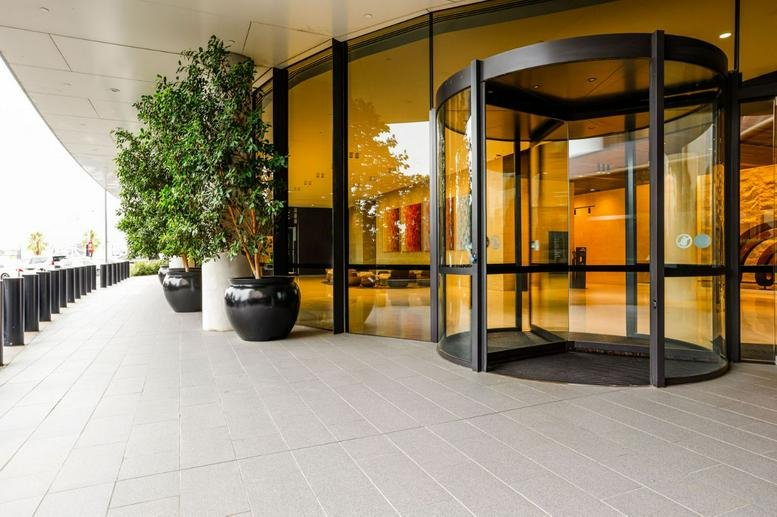 Building entrance with a glass revolving door at Chadstone Tower 1.
