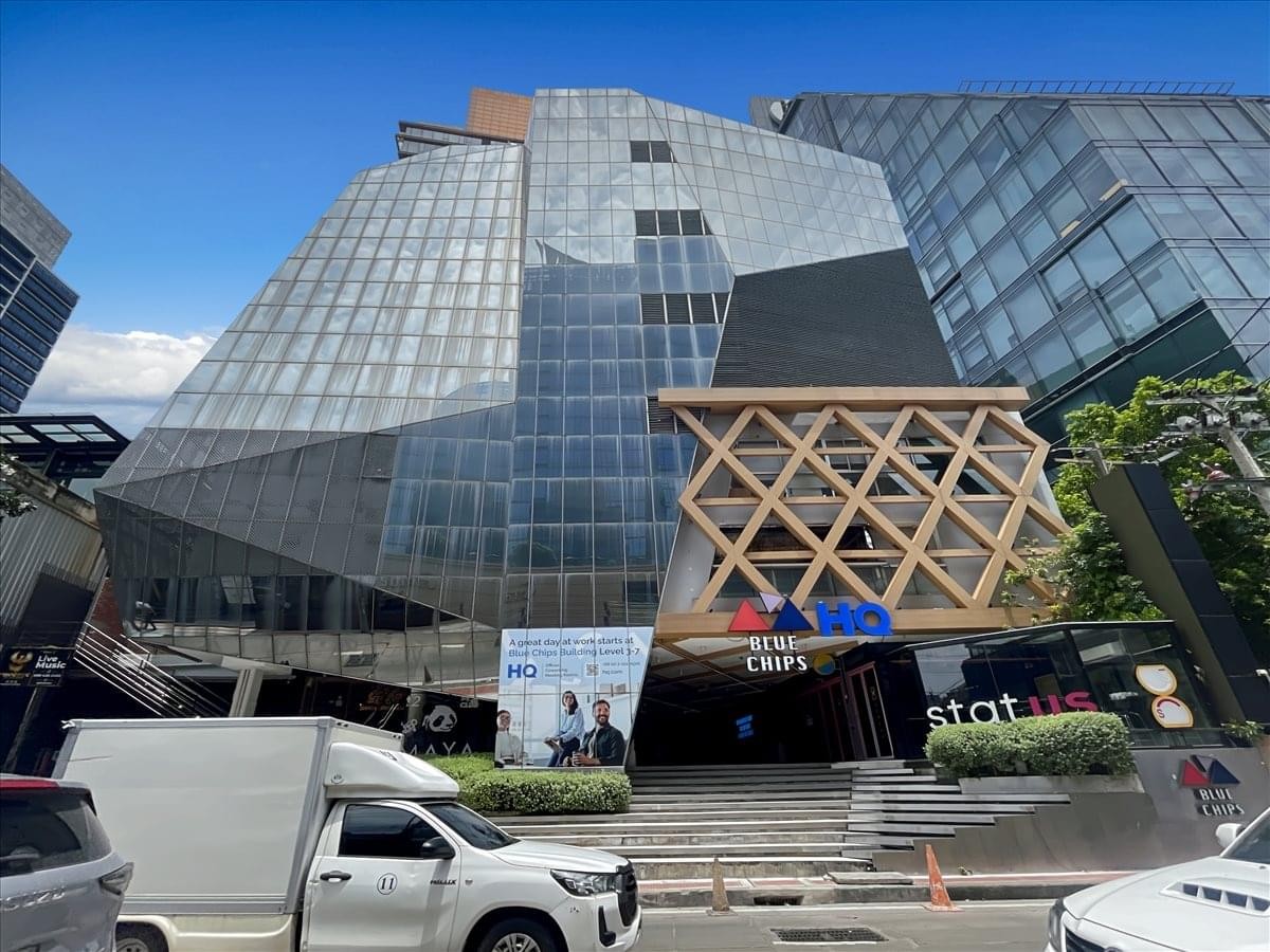 Modern architectural exterior of the Blue Chips Building under a clear blue sky.
