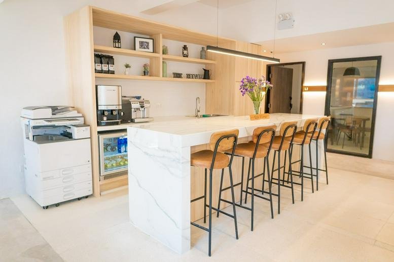 Communal kitchen area at Liberal Factory Building featuring a marble breakfast bar and coffee station.