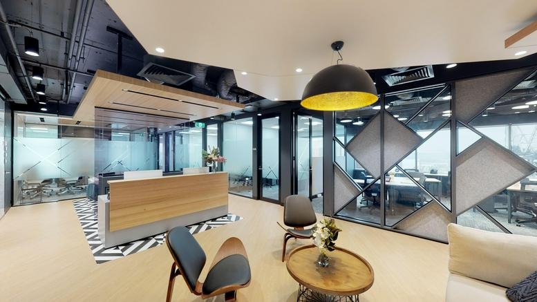 Modern reception area at 141 Walker Street, Sydney featuring a wooden desk and designer pendant light.