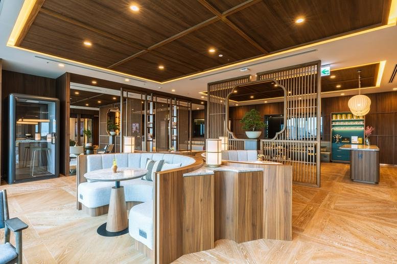 Spacious lounge at 14F-15F, No. 525, Sec. 4, Zhongxiao E. Rd with curved seating and warm wood paneling.