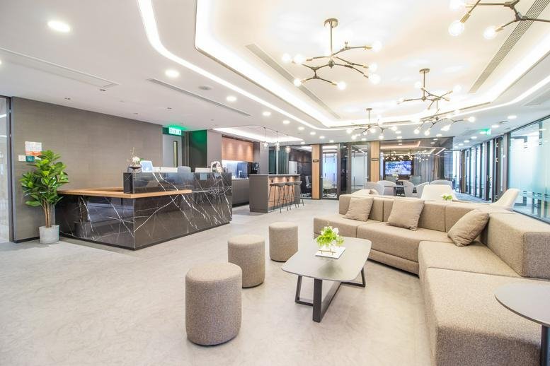 Spacious reception area with marble desk, lounge seating, and designer lighting at Admiralty Centre Tower 1.