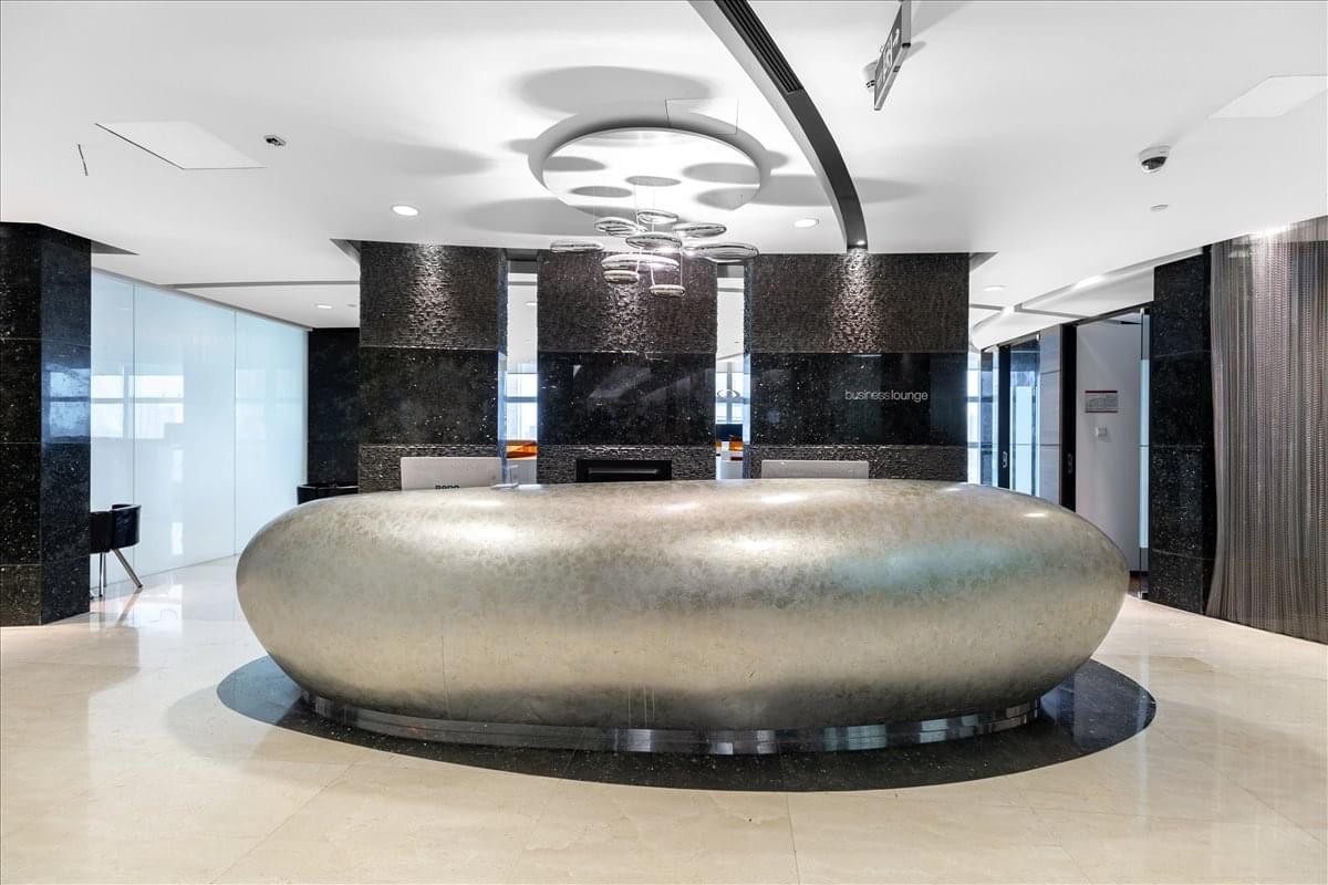 Modern reception area featuring a unique silver pebble-shaped front desk.