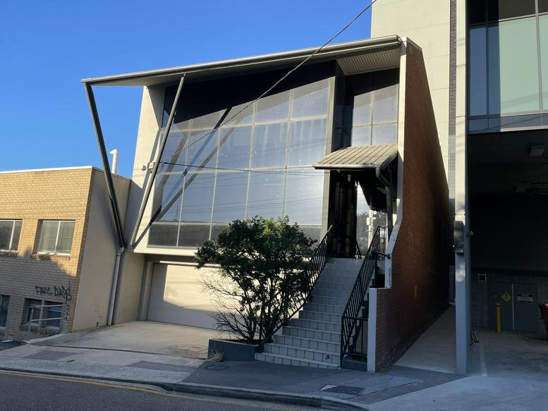Exterior view of the modern glass-fronted building at 15 Wren Street.