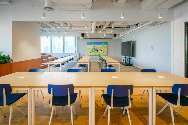 Spacious communal training area at Tiandi Tower A1 with long tables and tiered wooden seating.