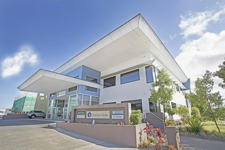 Modern exterior of the building at 155 Varsity Parade with a large white cantilevered roof and glass entrance.