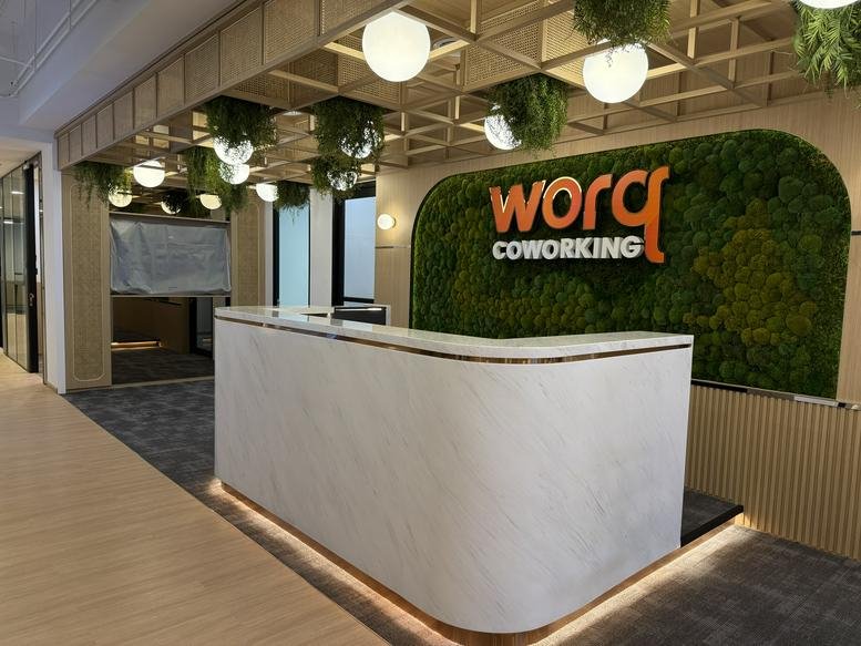 Modern reception desk at 158, Jalan Peel, Maluri, Kuala Lumpur featuring a lush green moss wall and wood accents.
