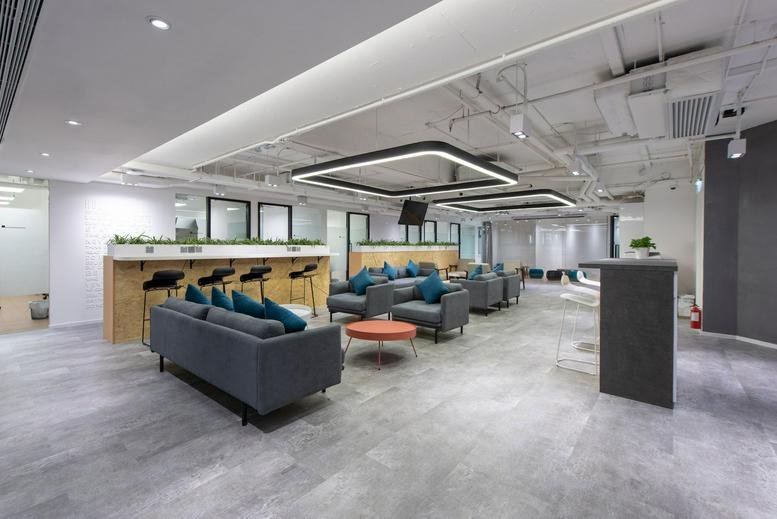 Spacious communal lounge with modern sofas and bar seating at New World Tower.