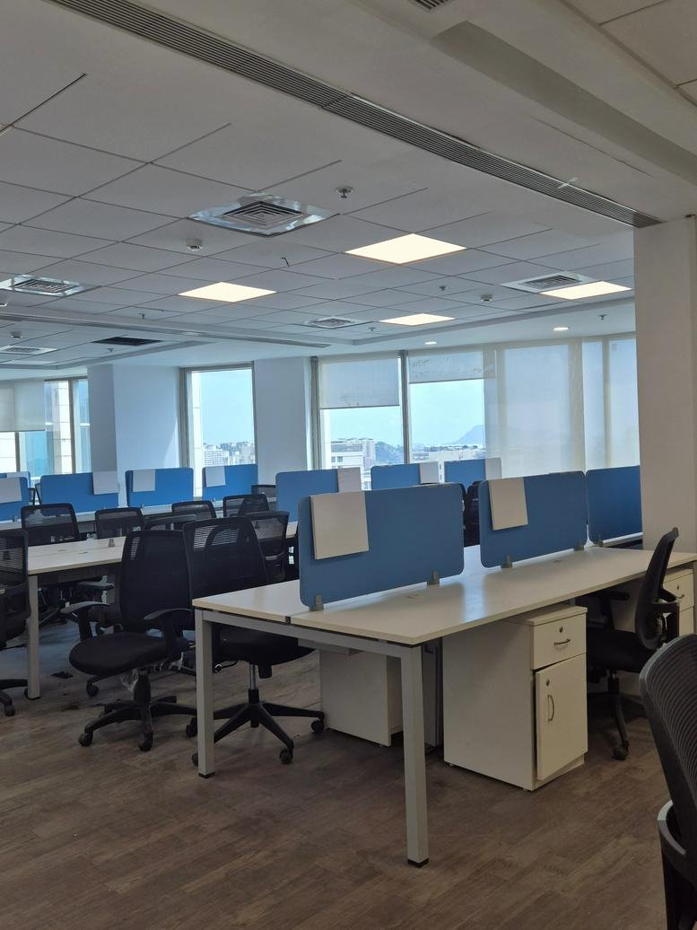 Spacious open-plan workspace at Lodha Supremus with rows of desks and natural light from large windows.