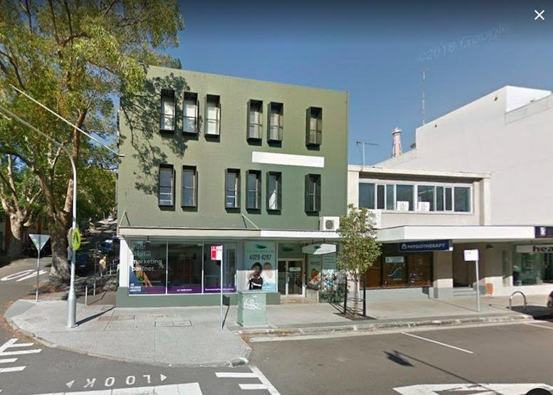 Exterior view of the green-painted building at 161 King St, Level 2, Newcastle.