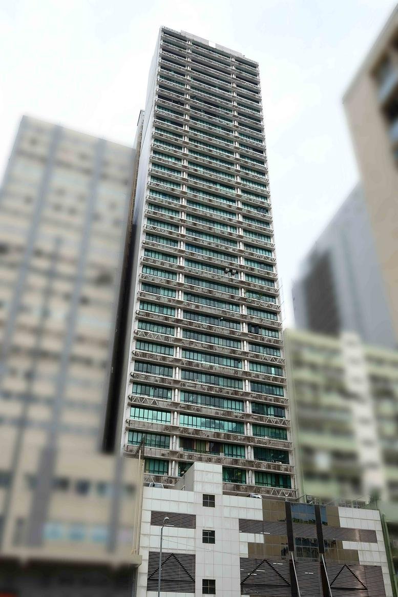 Exterior view of the high-rise New Trend Centre building against a bright sky.