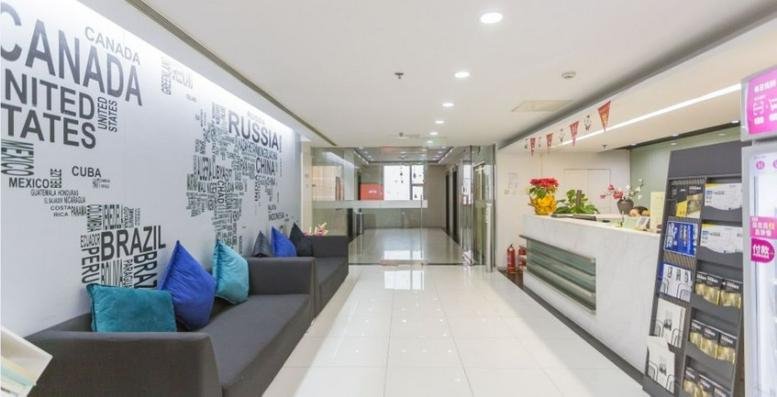 Bright reception area of Star City International with a world map wall mural and comfortable lounge seating.