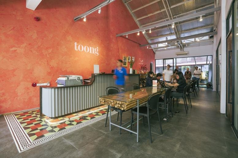 Vibrant reception area at 186–188 Vo Thi Sau Street, Xuan Hoa Ward with a red feature wall and patterned floor.