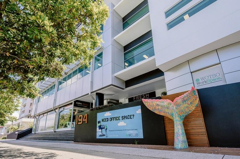 Modern exterior facade and entrance of 194 Varsity Parade with a decorative whale tail sculpture.