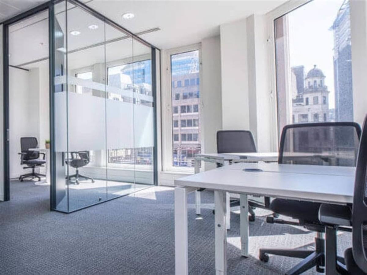 Spacious, modern office workspace with large windows and glass partitions at Nishihankyu Building.