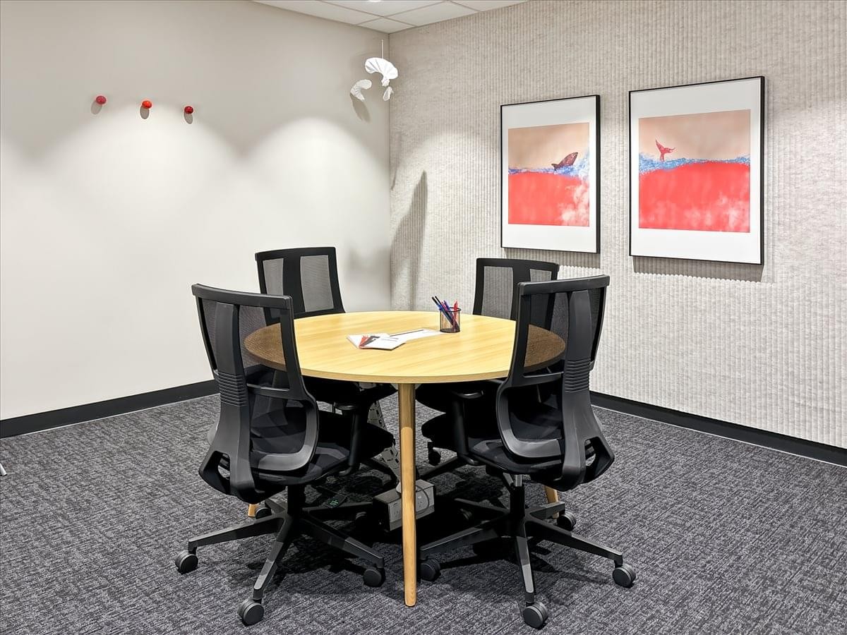 Meeting room at 2-3 Greenhill Road, Wayville, with a round wooden table and four mesh chairs.