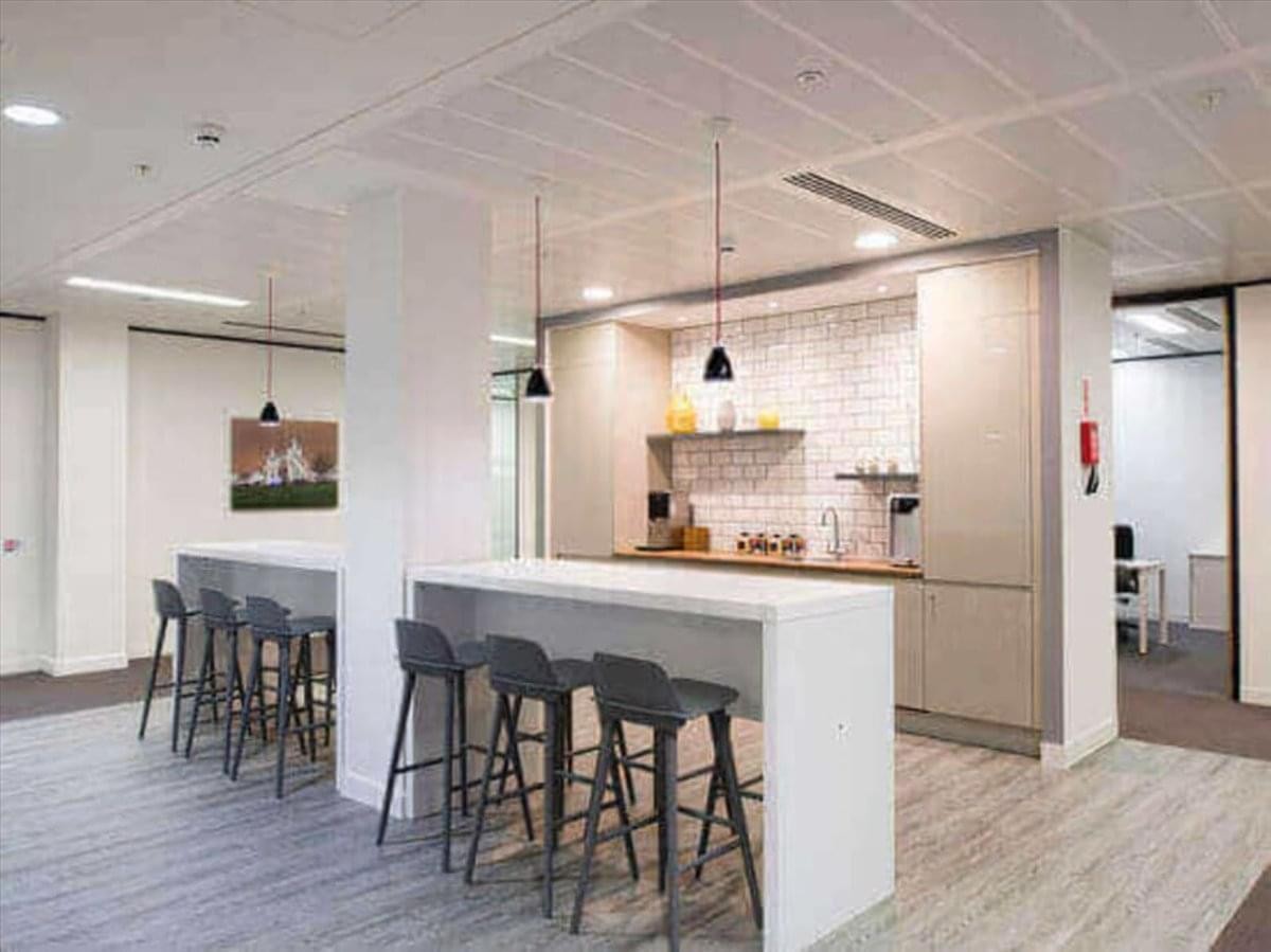 Modern communal kitchen and dining area at 2-4-6 Kanaikecho with high-top breakfast bars.