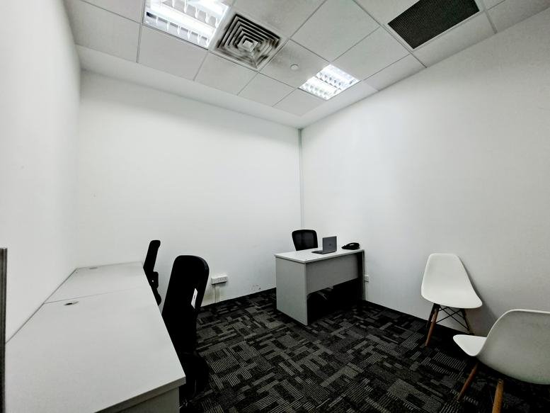 Private office at Vision Exchange, 2 Venture Drive, featuring multiple workstations and modern grey carpeting.