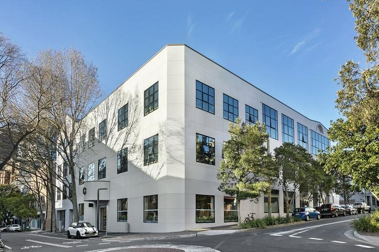 Exterior view of the white corner building at 20-40 Meagher Street, Chippendale, Sydney, Australia.