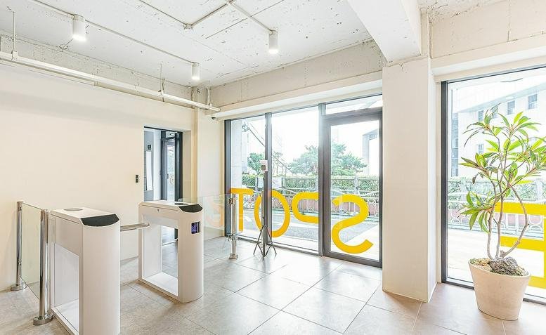 Entrance of 20, Wausan-ro 23-gil, Hongdae 2, Seoul featuring electronic security turnstiles and glass doors.