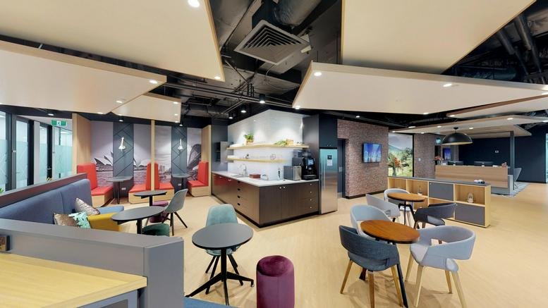 Spacious communal breakout area at 207 Kent Street with diverse seating and ceiling baffles.