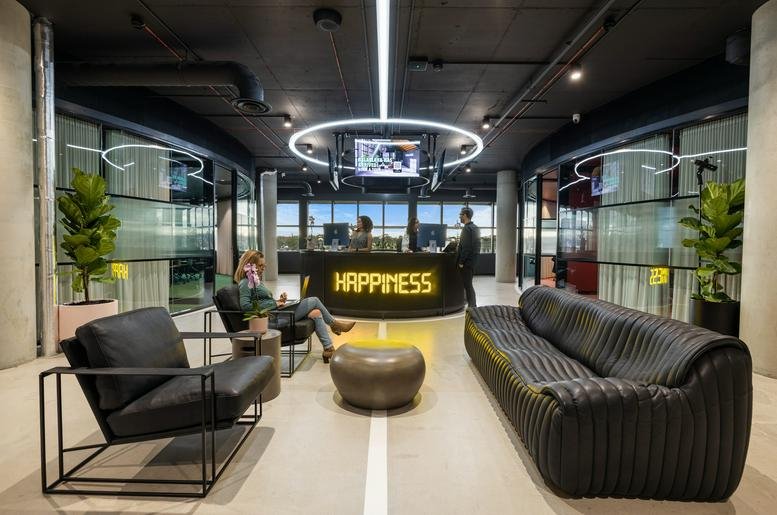 Spacious reception lobby at 21 William Street, Balaclava featuring a glowing Happiness desk and lounge seating.