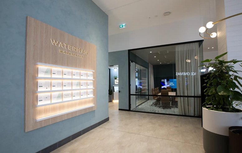 Bright reception area at 2107-2125, Dandenong Road, Clayton with light wood paneling and a branded feature wall.