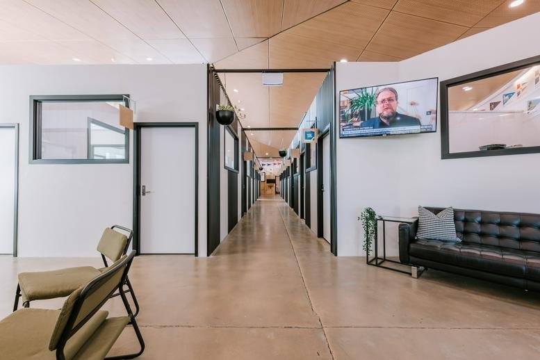 Bright hallway at 22 Ormsby Terrace, Mandurah, Western Australia featuring a lounge area and office suites.