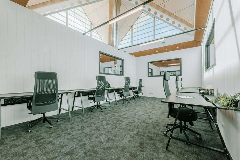 Open-plan workspace at 22 Ormsby Terrace, Mandurah, Western Australia with desks and ergonomic chairs.