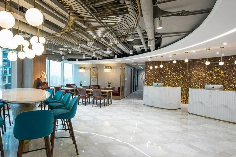 Spacious reception area at 22F, Shui On Plaza with white marble floors and a textured gold wall.