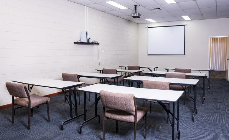 Classroom-style meeting room at 234A, Epsom Avenue, Perth, Western Australia with a projector screen.