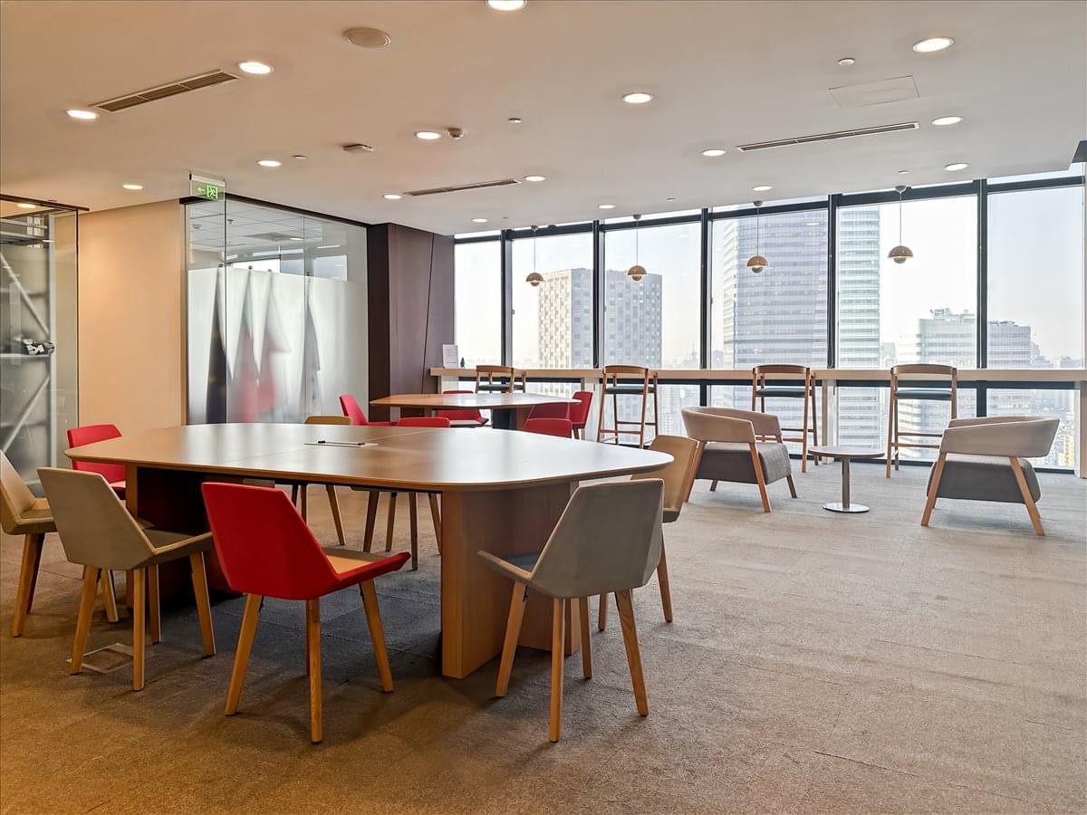 Spacious common area at Cloud 9 International Plaza featuring warm wood accents and city views.