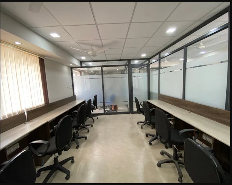 Open-plan office at 24, Sri Vari Ramakrishna Garden Main Rd with long desks and ergonomic black chairs.