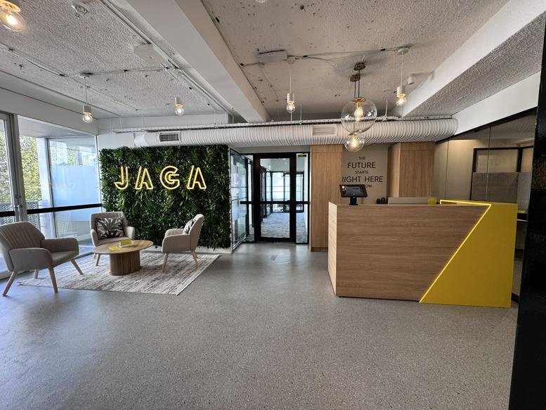 Modern lobby and reception area at Level 6, 241 Commonwealth Street with a green feature wall.