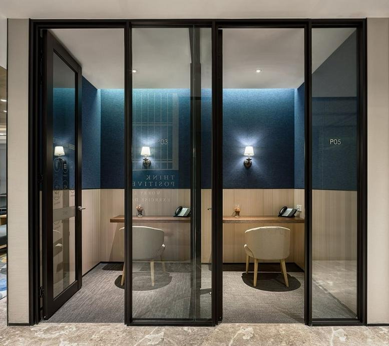 Professional workstations at Guangzhou South Media Centre with ergonomic chairs and blue feature walls.