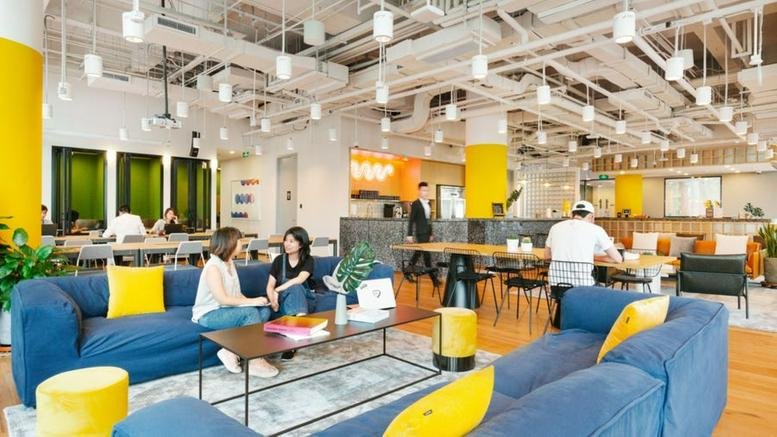 Spacious communal lounge at Shinmay Union Square, Building Phase 1, 999 Pudong R, Shanghai with blue sofas and yellow accents.