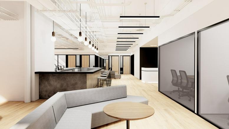 Spacious communal lounge and kitchen area at Enterprise Square 5 with modern lighting and wood floors.
