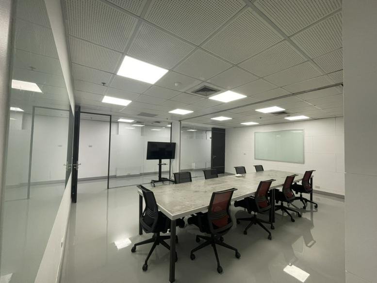 Professional board room at Homeplace office building with a long table and modern ergonomic chairs.