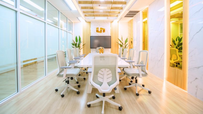 A professional boardroom at 29 Vanissa Building with a long white table and modern white mesh chairs.