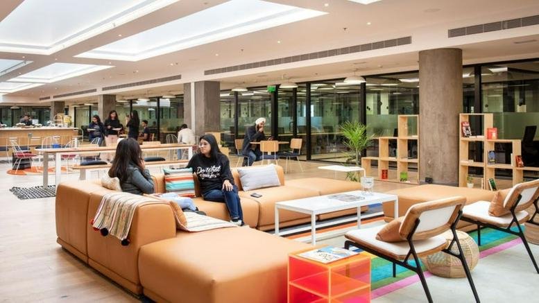 Spacious communal lounge at 2F, Embassy Quest, featuring leather sofas and skylights.