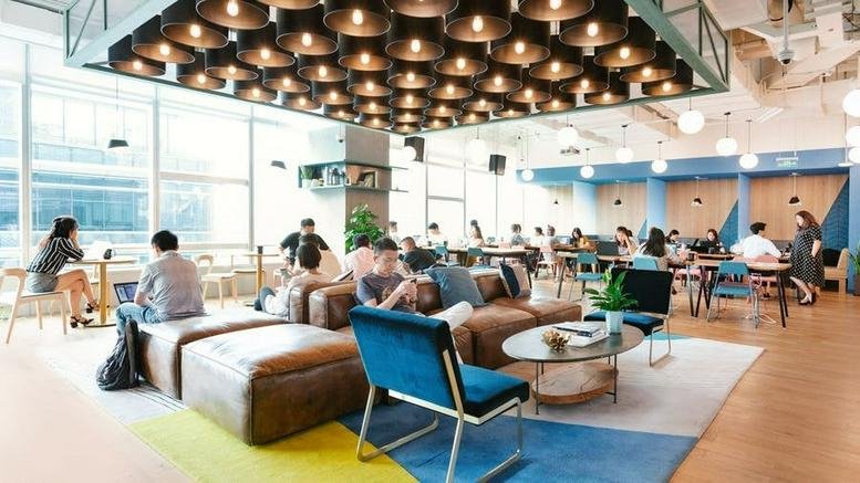 Spacious communal lounge at 293 Guangzhou Middle Avenue with mid-century furniture and a designer light installation.