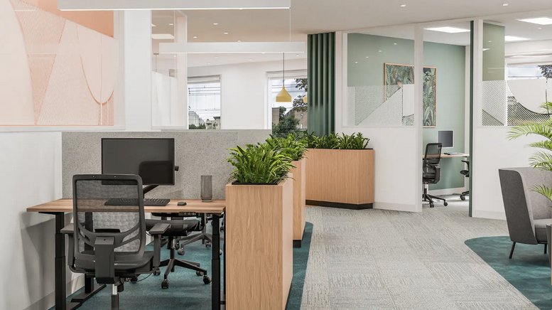 Spacious coworking area at 3 Hamilton Street with wooden planters, teal carpets, and modern workstations.