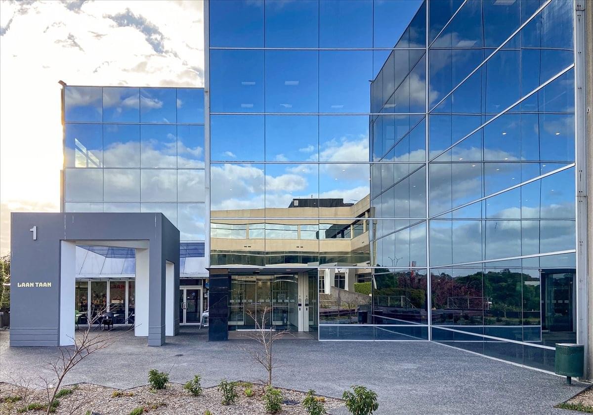 Exterior view of the blue glass-facade building at 301 Burwood Highway.