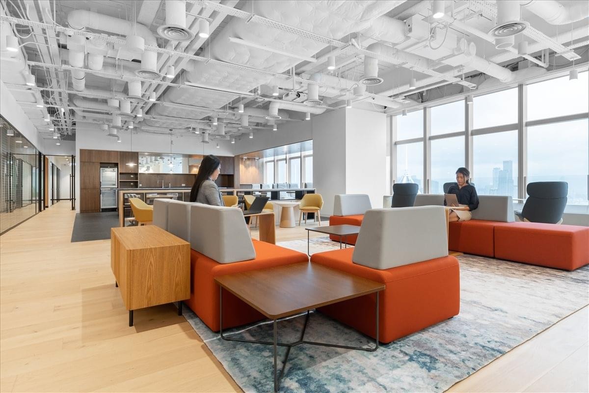 Vibrant coworking space at Hysan Place, 31-32/F, 500 Hennessy Road with orange sofas and city views.